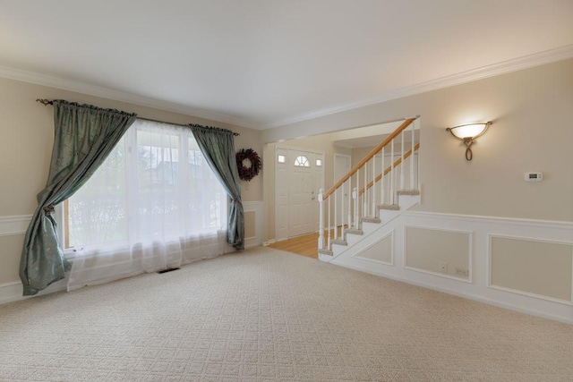 interior space featuring crown molding and carpet flooring