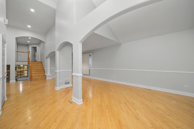 interior space with light wood-type flooring and high vaulted ceiling