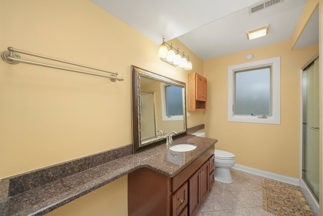 bathroom with walk in shower, vanity, tile patterned flooring, and toilet