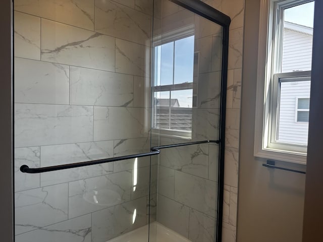 bathroom with a shower with shower door