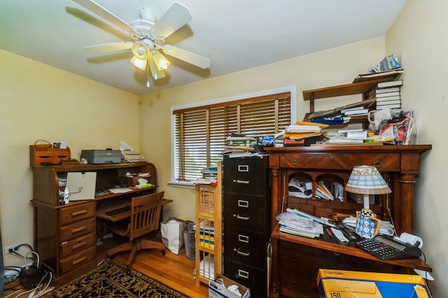 home office featuring hardwood / wood-style floors and ceiling fan