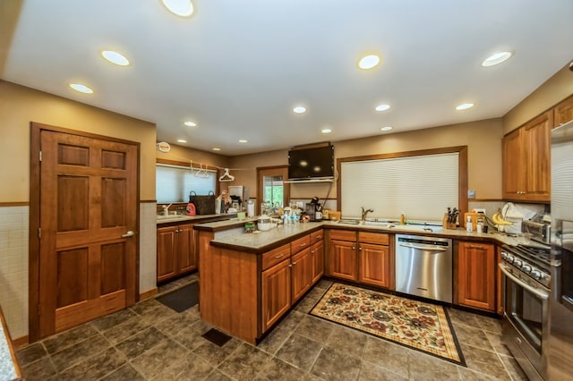 kitchen with wall oven, dark tile floors, kitchen peninsula, and stainless steel dishwasher