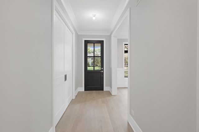 doorway to outside featuring ornamental molding and light wood-type flooring