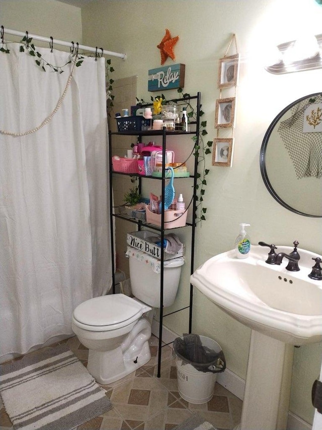 bathroom featuring tile patterned floors and toilet