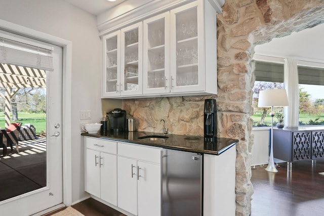 kitchen featuring fridge, dark hardwood / wood-style flooring, backsplash, sink, and white cabinetry