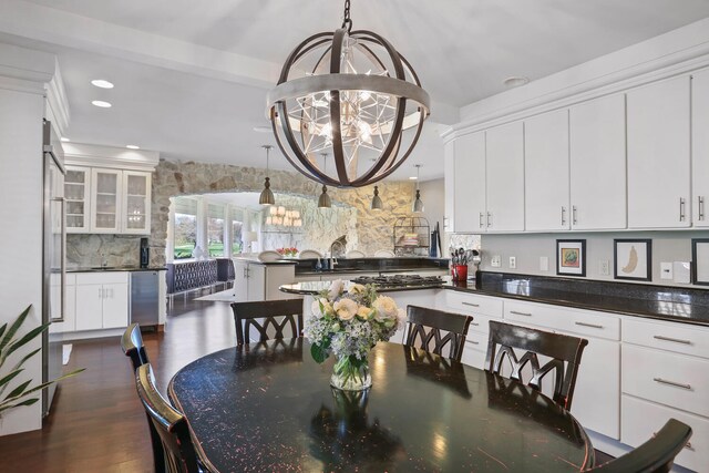 dining room with a chandelier and dark wood-type flooring