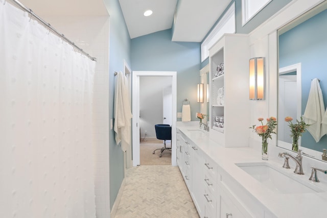 bathroom featuring dual bowl vanity, tile flooring, and lofted ceiling