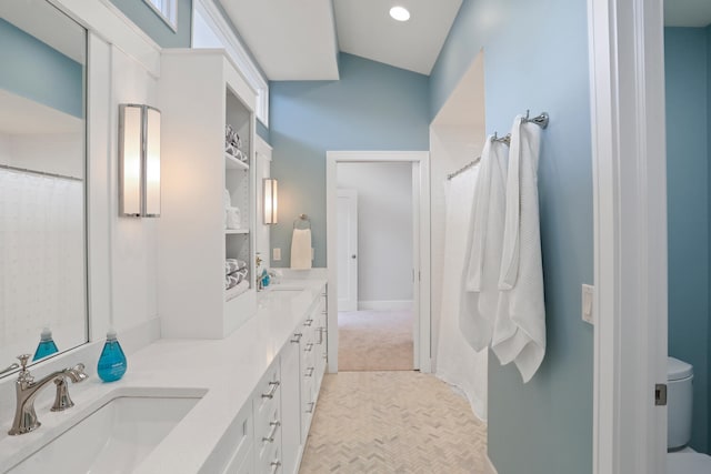 bathroom featuring double vanity, tile flooring, and toilet