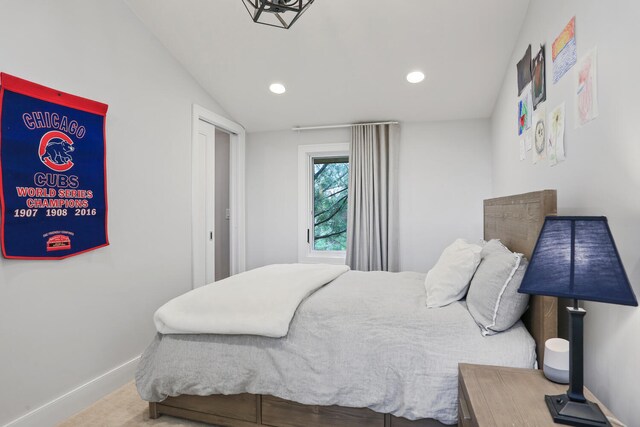 carpeted bedroom featuring vaulted ceiling