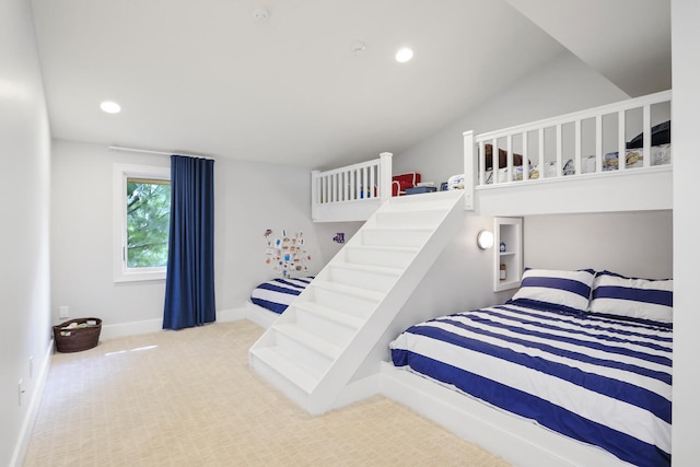 bedroom with lofted ceiling and light colored carpet