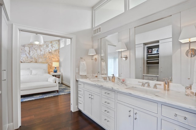 bathroom featuring wood-type flooring and dual bowl vanity