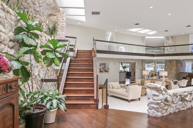 interior space featuring a high ceiling and wood-type flooring