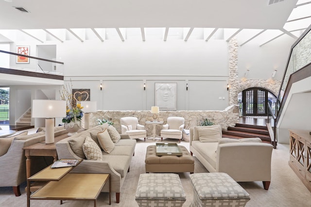 carpeted living room with a high ceiling