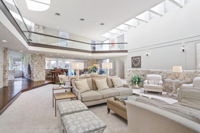 living room with a high ceiling and light hardwood / wood-style floors