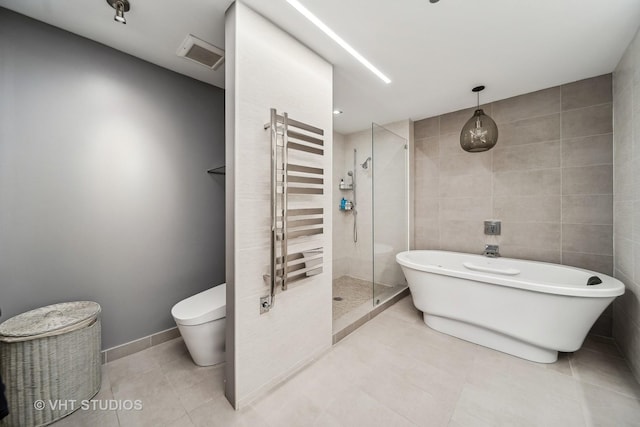 bathroom featuring radiator, tile walls, tile patterned floors, shower with separate bathtub, and toilet