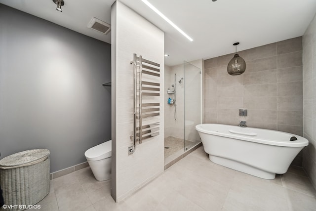 bathroom with tile walls, independent shower and bath, toilet, tile patterned floors, and radiator heating unit