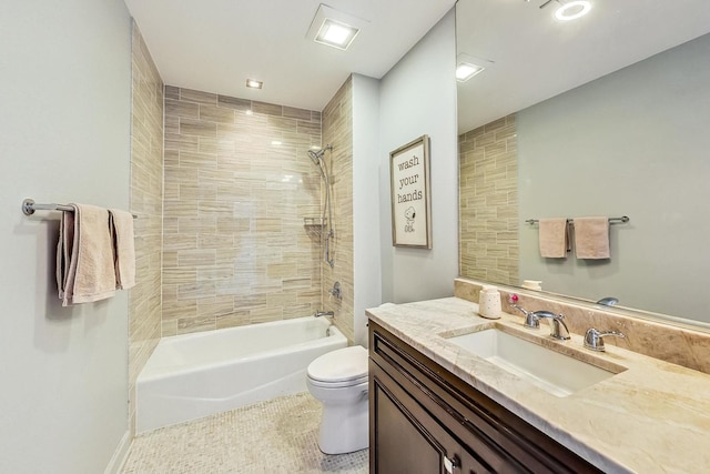 full bathroom with tile patterned floors, vanity, tiled shower / bath combo, and toilet