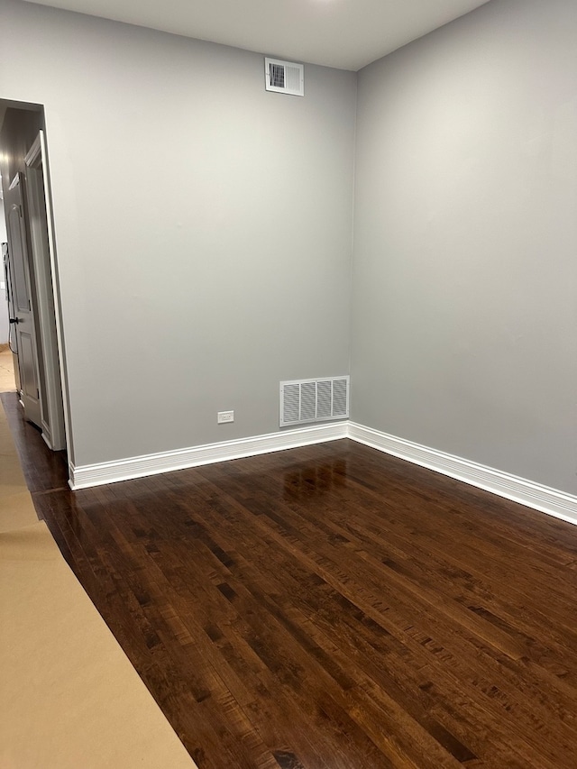 spare room with dark hardwood / wood-style floors