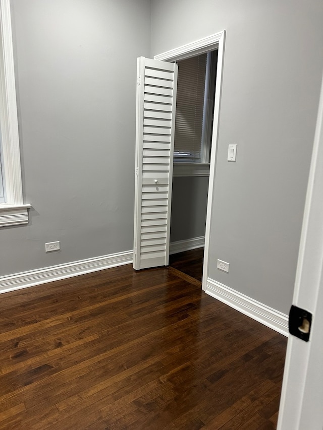 spare room featuring dark hardwood / wood-style flooring