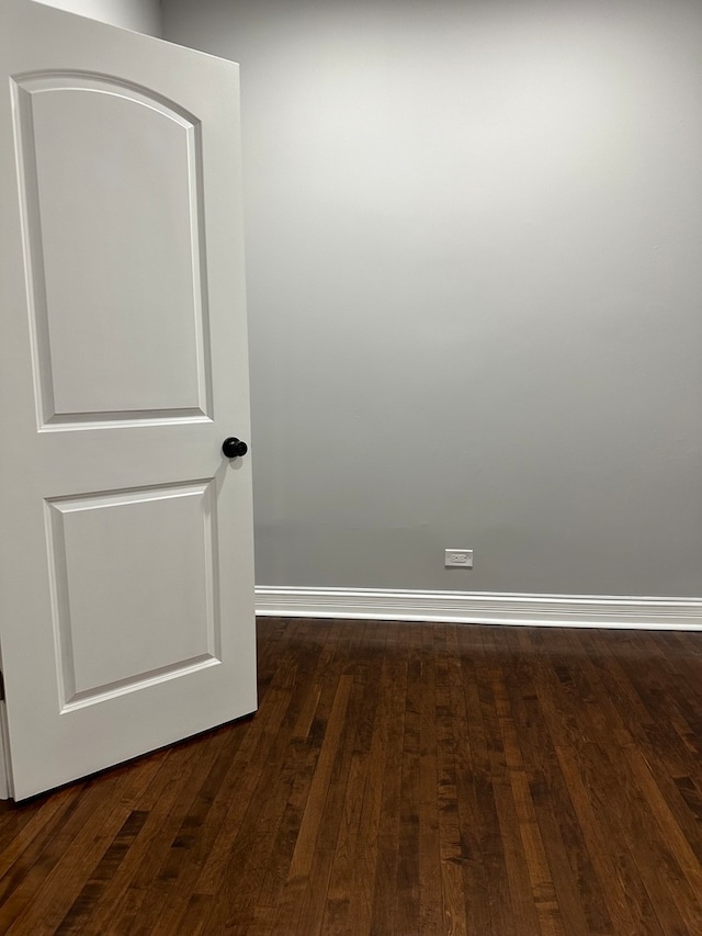 spare room with dark hardwood / wood-style flooring