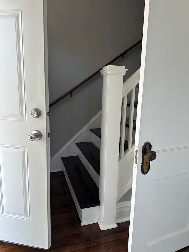 staircase with dark wood-type flooring