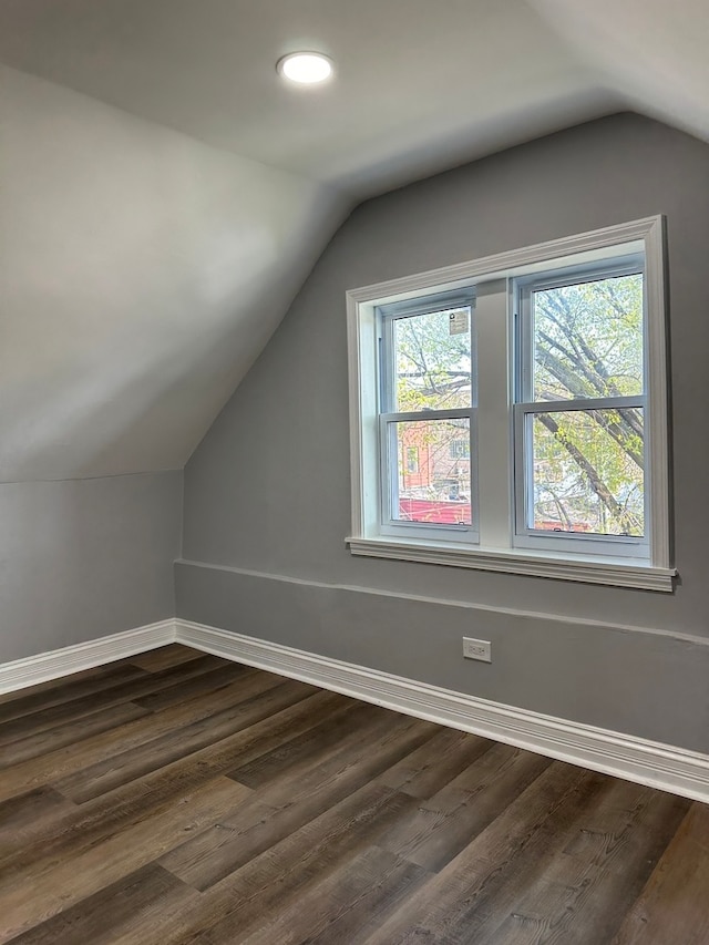 bonus room featuring dark hardwood / wood-style floors and lofted ceiling