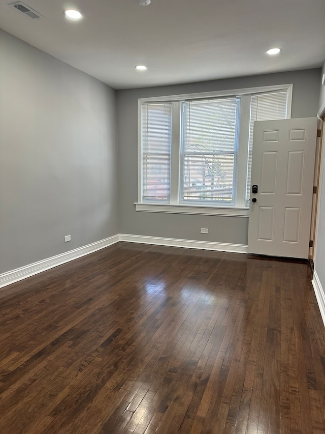 unfurnished room featuring dark wood-type flooring