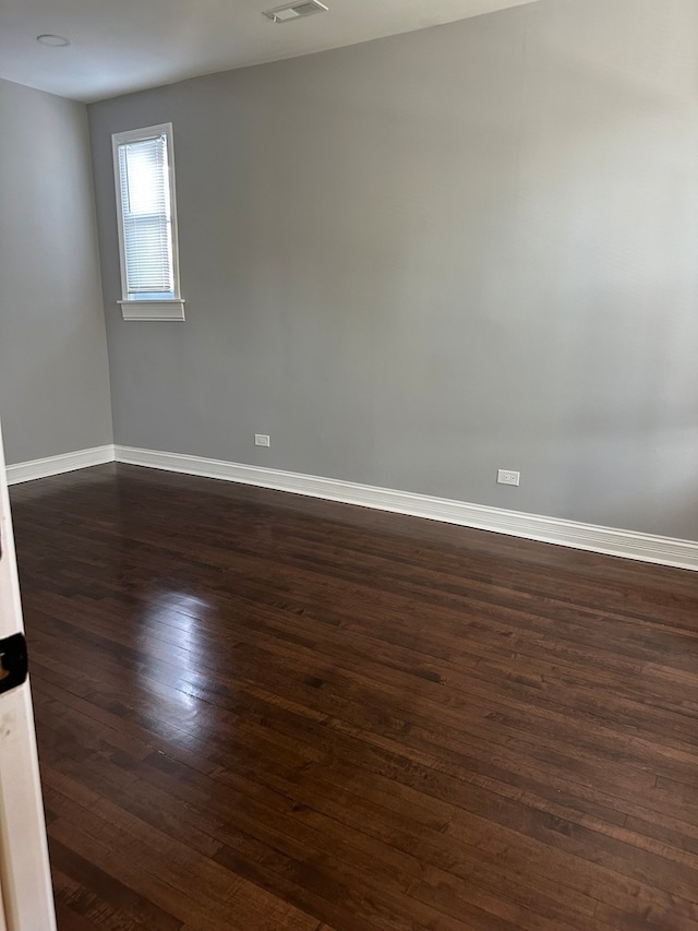 unfurnished room featuring dark wood-type flooring