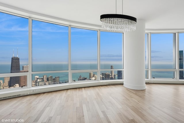 401 N Wabash Ave Unit 75A, Chicago, IL 60611 - unfurnished sunroom featuring healthy amount of natural light, a water view, and a chandelier