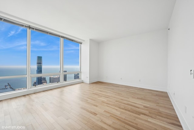 401 N Wabash Ave Unit 75A, Chicago, IL 60611 - unfurnished room with a water view, light wood finished floors, and floor to ceiling windows