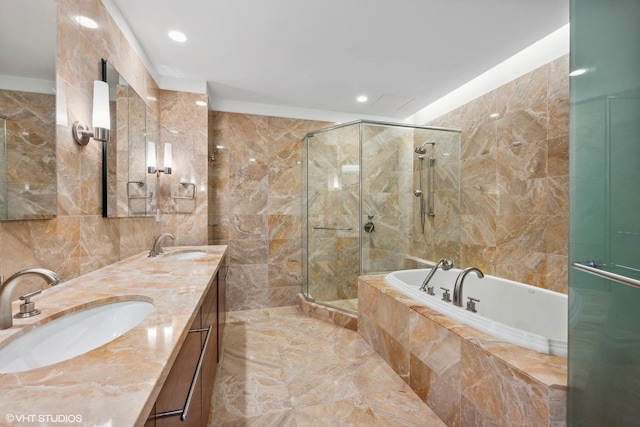 bathroom with vanity, independent shower and bath, and tile walls