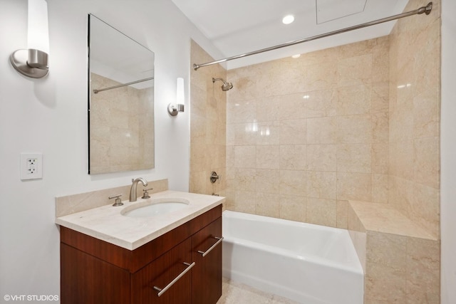 bathroom with vanity and tiled shower / bath combo