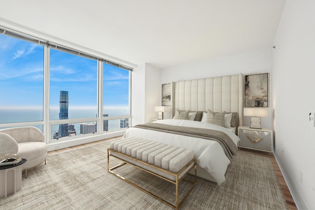 401 N Wabash Ave Unit 75A, Chicago, IL 60611 - bedroom with wood finished floors, a water view, and a wall of windows