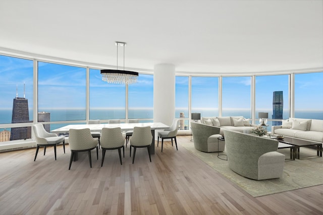 sunroom / solarium with a water view and a chandelier