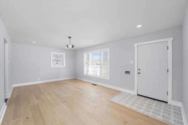 entrance foyer with light wood finished floors, recessed lighting, visible vents, and baseboards