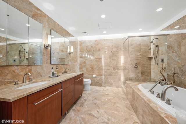 full bathroom featuring tile flooring, tile walls, toilet, and dual sinks