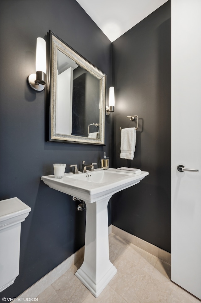 bathroom with toilet and tile floors