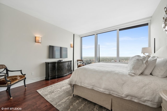 bedroom with floor to ceiling windows and dark wood-type flooring