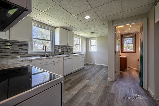 kitchen with range, white cabinets, sink, dark hardwood / wood-style floors, and white dishwasher