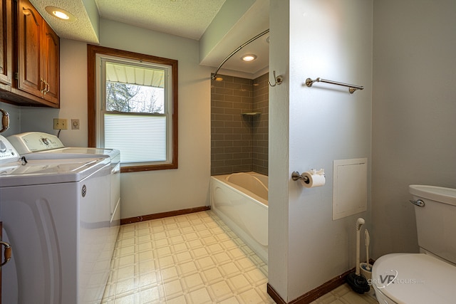 laundry room featuring washing machine and clothes dryer and light tile floors