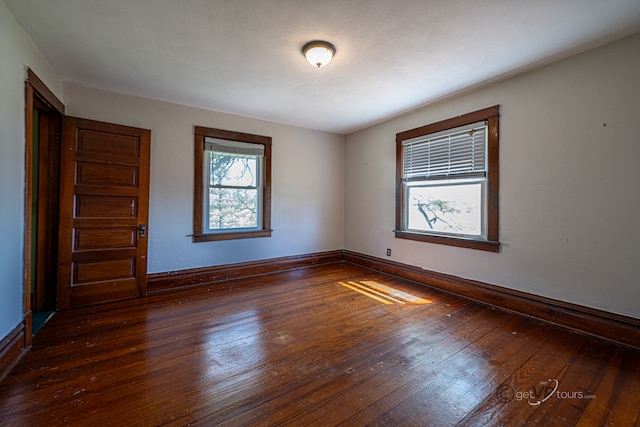 spare room with dark hardwood / wood-style flooring