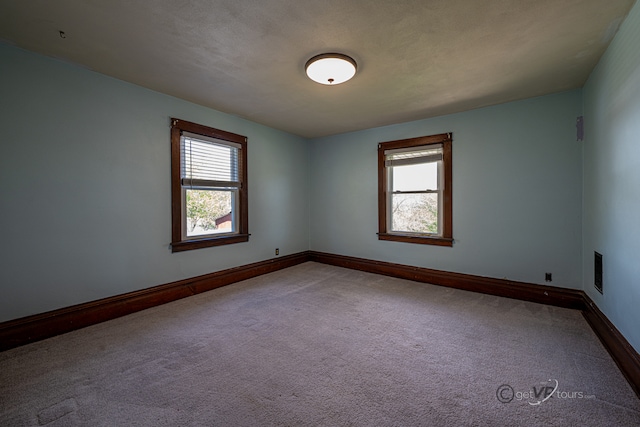 spare room featuring carpet