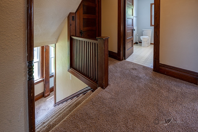 corridor featuring tile flooring and a textured ceiling