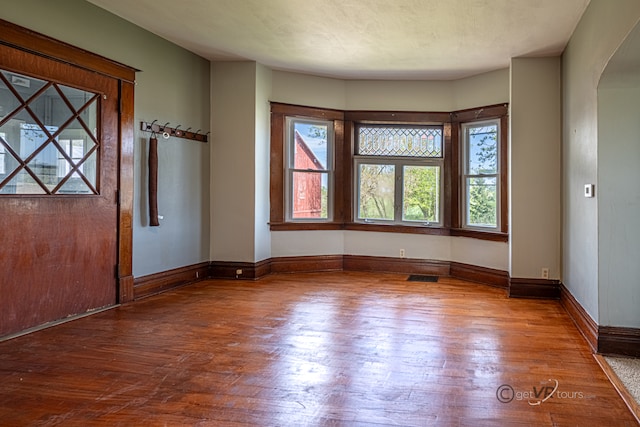 spare room with wood-type flooring