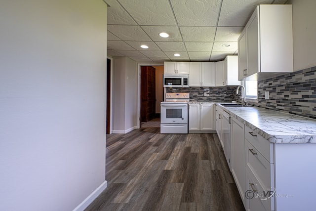 kitchen featuring white electric stove, dark wood-type flooring, white cabinets, and sink