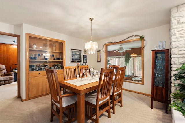 carpeted dining room featuring a chandelier