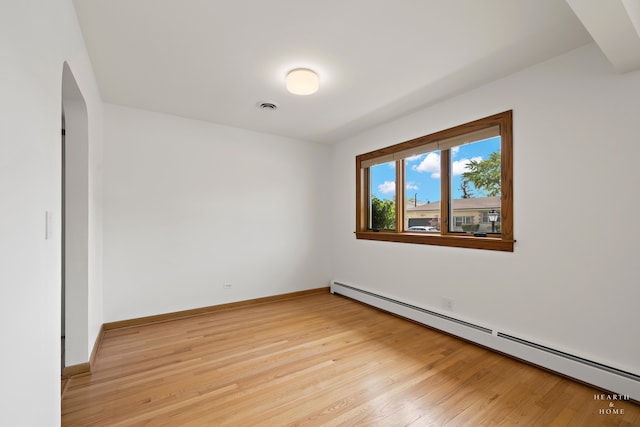 unfurnished room featuring light hardwood / wood-style flooring and baseboard heating