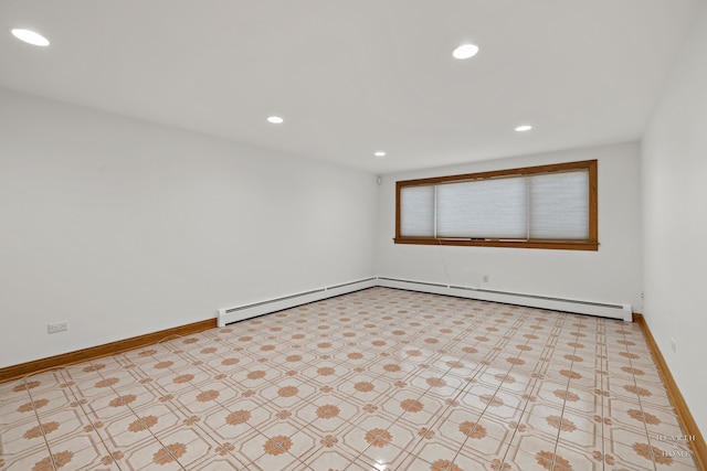 tiled empty room with a baseboard heating unit