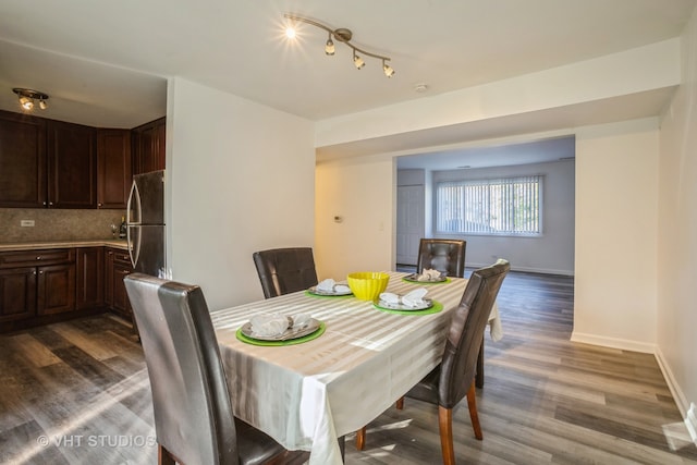 dining area featuring dark wood-type flooring