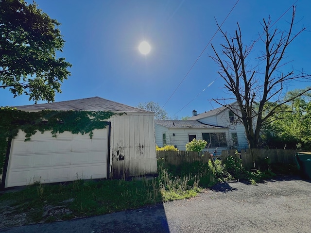 view of side of property with an outdoor structure and a garage